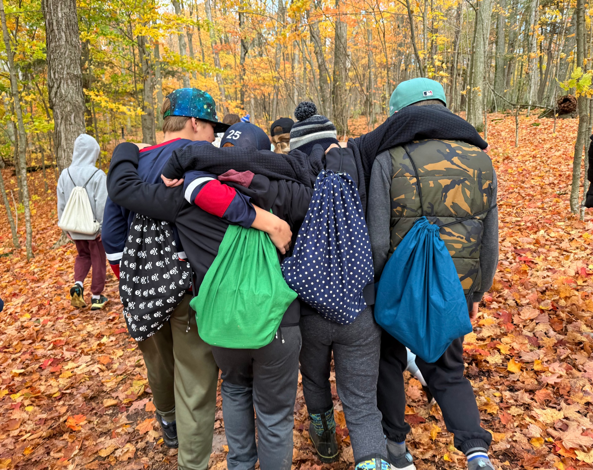 Students with drawstring bags at Lemoine Point in autumn
